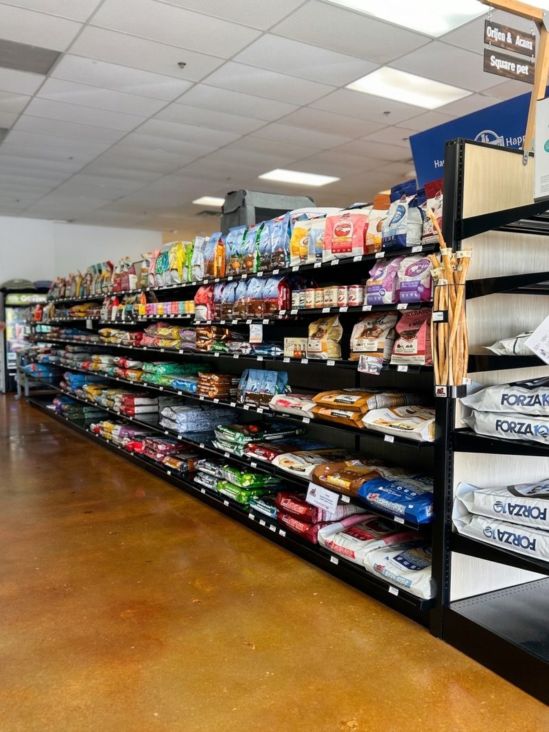 A long aisle of dry dog food with Orijen, Acana and Forza10 bags